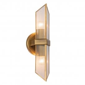 a modern wall scone in vintage brass finish with ribbed glass shade