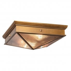 a modern flush ceiling light in vintage brass finish with ribbed glass panels