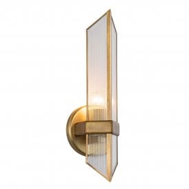 contemporary linear wall light in a vintage brass finish and ribbed glass 