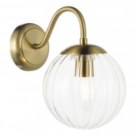 natural brass wall light with a clear glass shade
