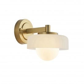 a modern brushed brass wall sconce with opal glass shade in a mid centuray style