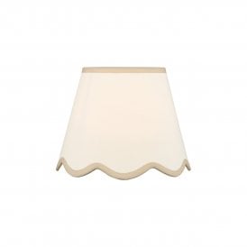 A neutral scalloped edge table lamp shade with taupe accent edging