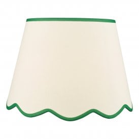 A large, neutral scallop shade lamp shade with green edge detail 