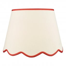 A large, neutral scallop shade lamp shade with red edge detail