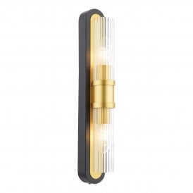 A matt black and gold slim wall light with ribbed glass shade in an art deco inspired design