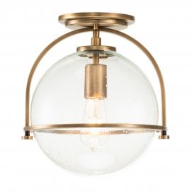 Brass flush mount ceiling light with clear glass globe