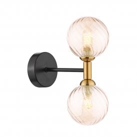 a modern wall light in a matt black and bronze finish with two bulbs featuring two decorative twisted amber glass globe shades
