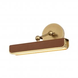 modern wall light to artwork in vintage brass finish and brown vegan lather accents 
